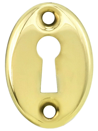 Stamped Brass Oval Keyhole Cover in Polished Brass.